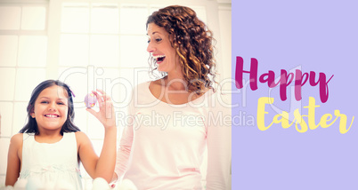 Composite image of happy girl holding easter egg