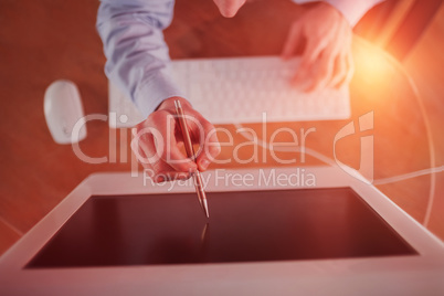 Businessman pointing to screen with pen