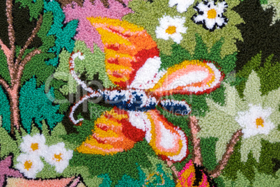 Needlework, a fragment of woven panels depicting butterflies.