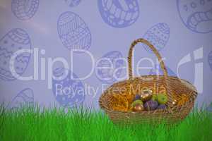 Composite image of easter eggs in paper nest basket