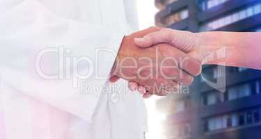 Composite image of doctor shaking hands with patient