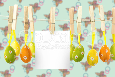 Composite image of hanging easter eggs