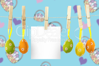 Composite image of hanging easter eggs