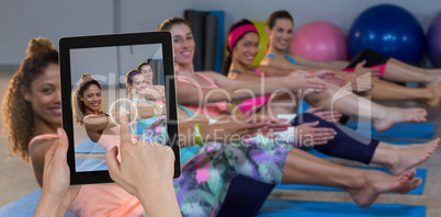 Composite image of hands touching digital tablet against white background