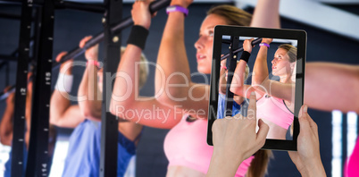 Composite image of hands touching digital tablet against white background