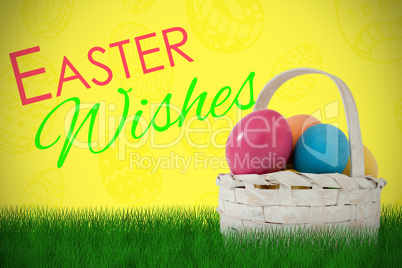 Composite image of easter eggs in wicker basket