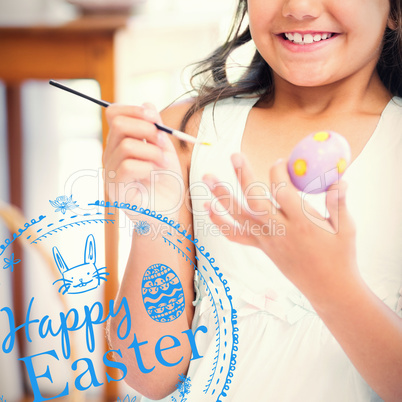 Composite image of cute girl painting easter eggs
