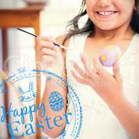 Composite image of cute girl painting easter eggs