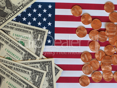 Dollar notes and coins and flag of the United States