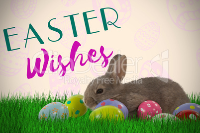 Composite image of brown bunny with colorful easter egg