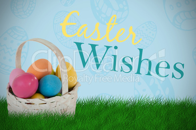 Composite image of mulit colored easter eggs in wicker basket