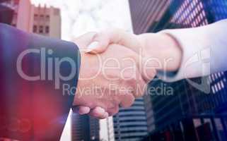 Composite image of business people doing handshake