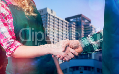 Composite image of male and female chefs shaking hands