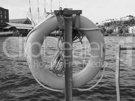 Life buoy by the river in black and white