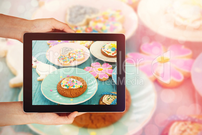 Composite image of close-up of hands holding digital tablet