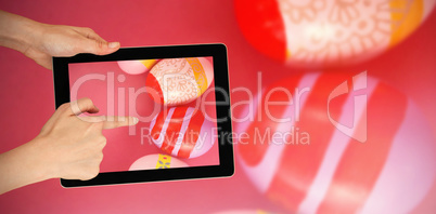 Composite image of hands touching digital tablet against white background