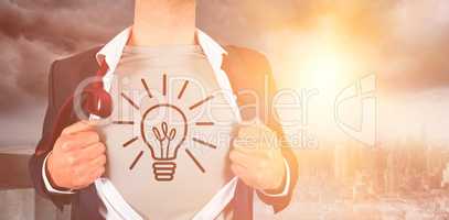 Composite image of businessman opening shirt with illuminated light bulb doodle