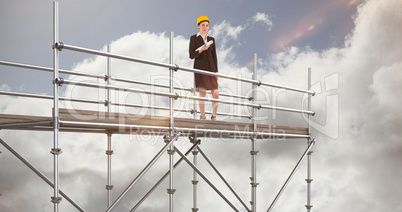 Composite image of smiling architect with hard hat