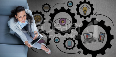 Composite image of woman on her tablet looking up