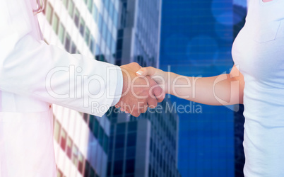 Composite image of doctor and patient shaking hands