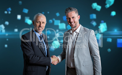 Composite image of smiling business partners shaking hands