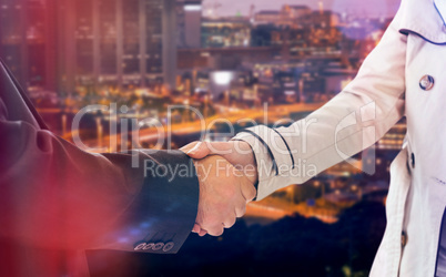 Composite image of ale and female corporate people shaking hands