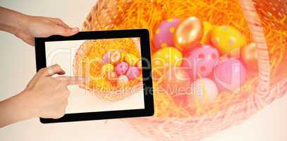 Composite image of hands touching digital tablet against white background