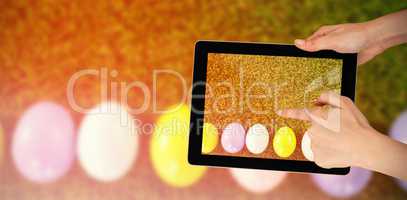 Composite image of hands touching digital tablet against white background