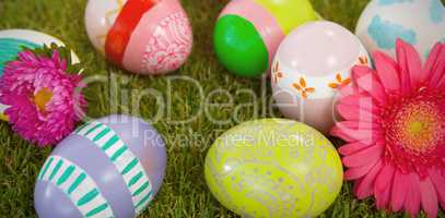 Painted easter eggs with flower on grass