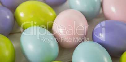 Multicolored Easter eggs on wooden surface