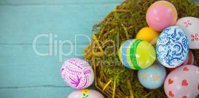 Painted Easter eggs against blue wood background
