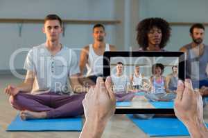 Composite image of cropped hand holding digital tablet