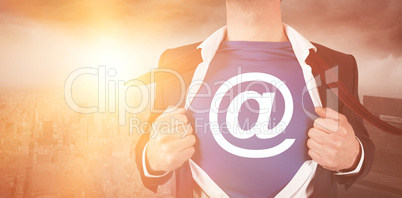 Cropped image of businessman opening shirt superhero style