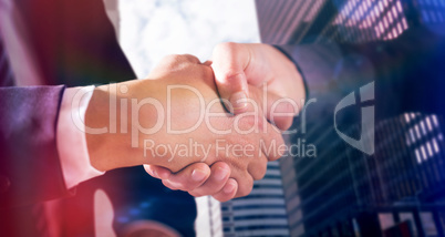 Composite image of male and female corporates shaking hands