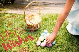 Composite image of little girl collecting easter eggs
