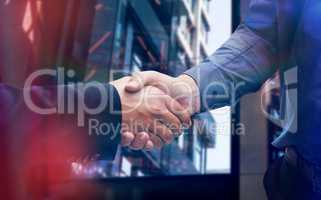 Composite image of corporate men shaking hands