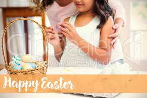 Composite image of happy mother and daughter painting easter eggs