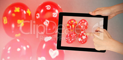 Composite image of hands touching digital tablet against white background