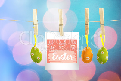 Composite image of hanging easter eggs