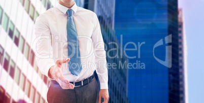 Composite image of smiling businessman offering handshake