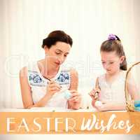 Composite image of mother and daughter painting easter eggs