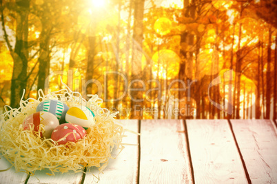 Composite image of patterned easter eggs in paper nest