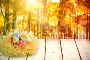 Composite image of patterned easter eggs in paper nest