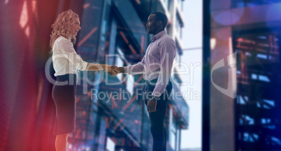 Composite image of corporate man and woman doing handshake