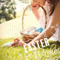 Composite image of little girl collecting easter eggs