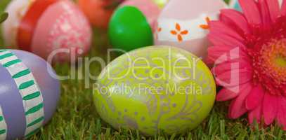 Painted easter eggs with flower on grass