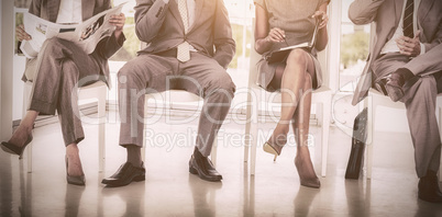 Business people sitting on chairs