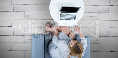 Composite image of woman on her laptop