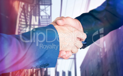 Composite image of male executives shaking hands