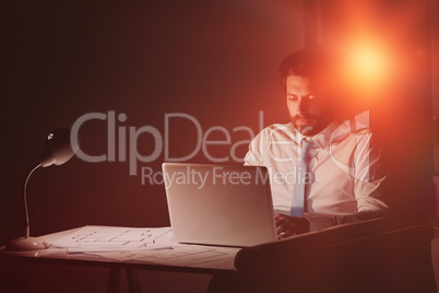 Businessman using laptop at night